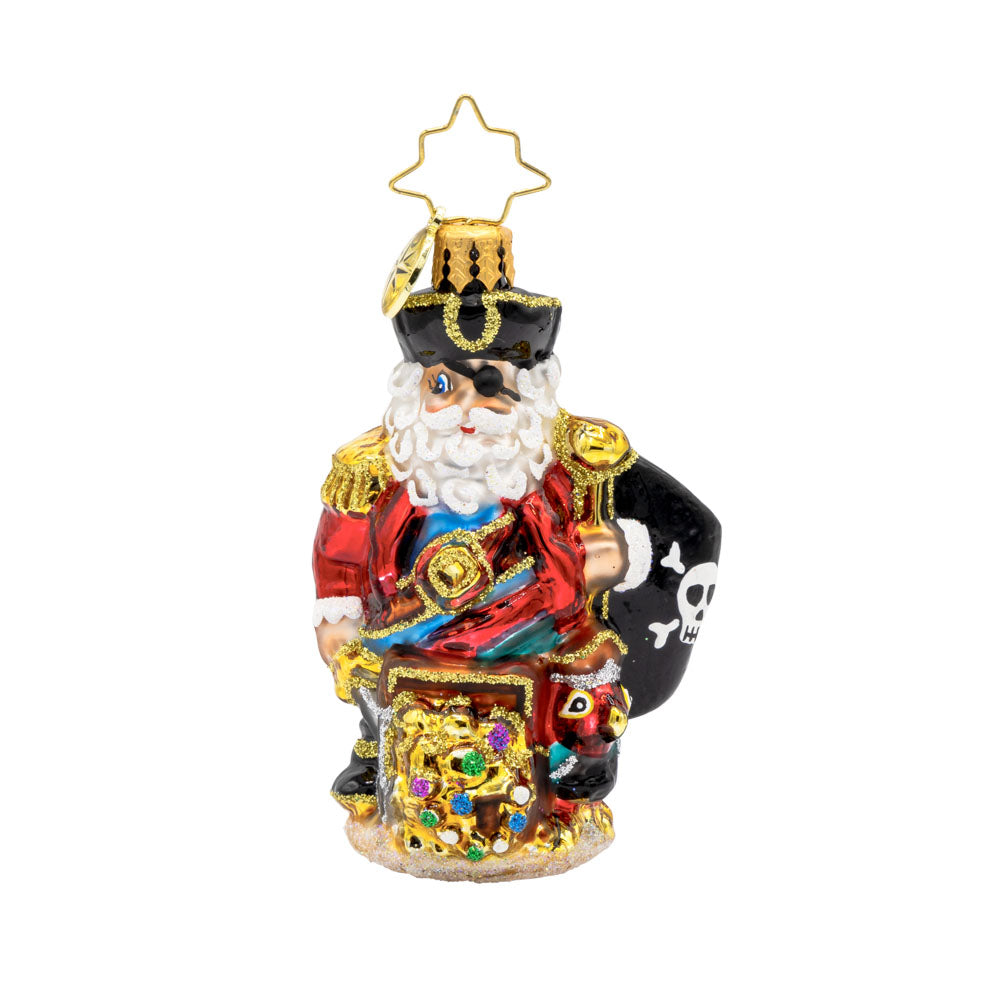 Swashbuckler Santa Gem ornament. Santa is dressed as a pirate, captains coat and eyepatch included. He sits atop a treasure chest with a pirate's flag in hand. View of front. 