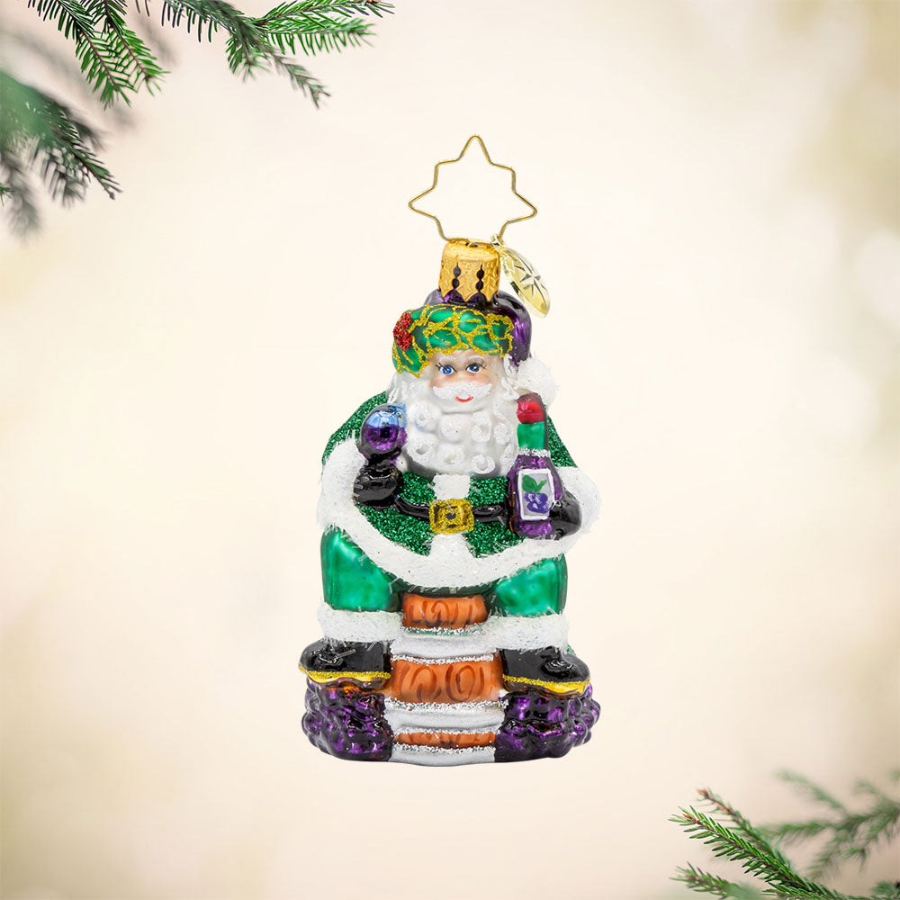 Time for Fine Wine Santa Gem ornament. Perched on a wine barrel, Santa holds a glass of wine and bottle. View of front.