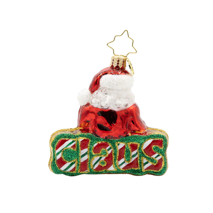 What’s in A Name Santa Gem ornament. Santa leans atop a green and red striped festive "Santa." View of back.
