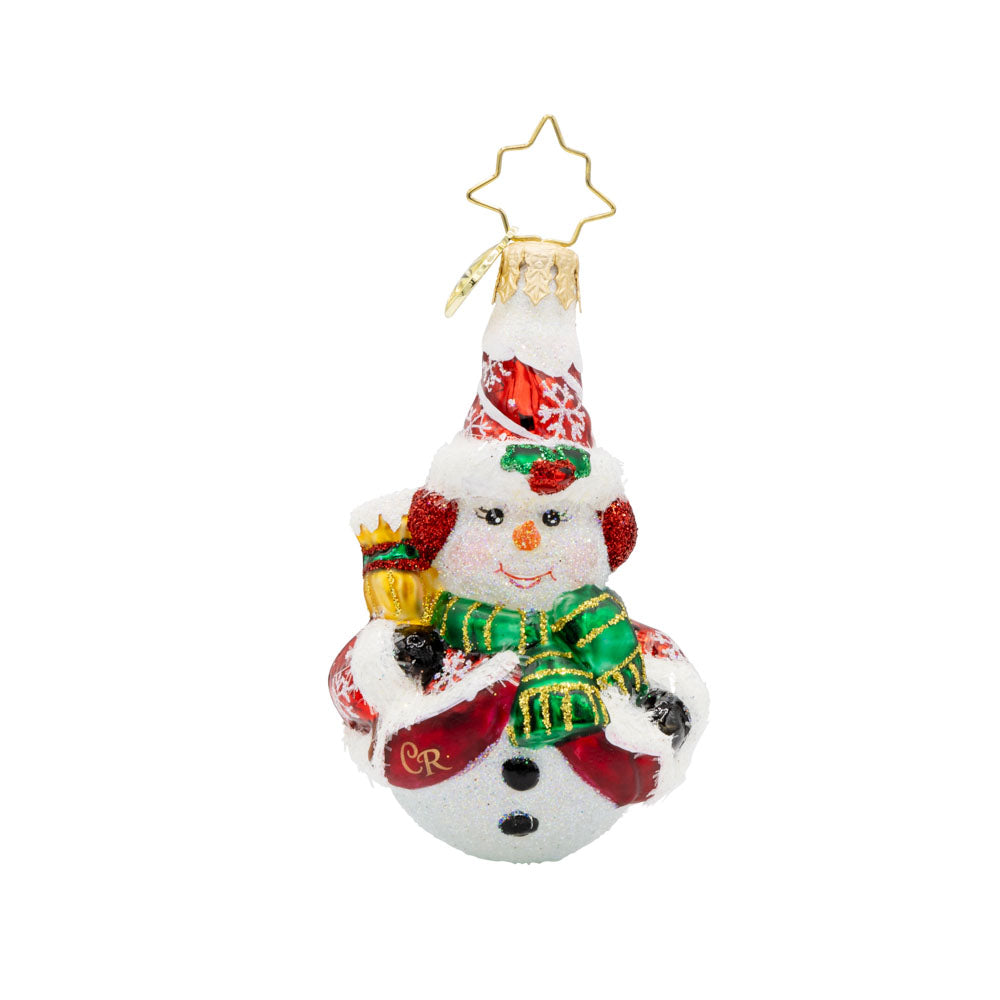Swept Up Snowman Gem ornament. A snowman donned in a red and snowflake flecked coat with a broom in hand. View of front.  