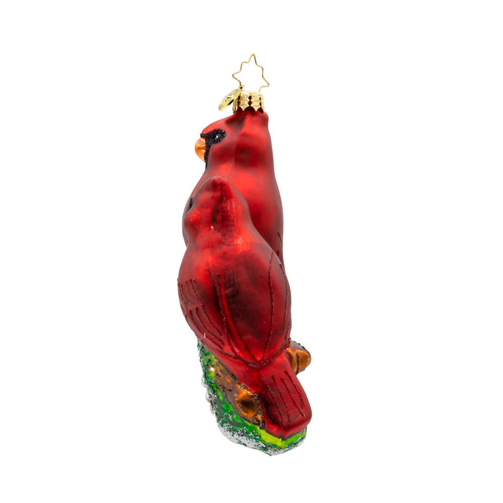 Cardinal Garden Greetings ornament. These cardinal birds are perched on a magnolia tree, with their shiny beaks and sparkling eyes. View of right side.
