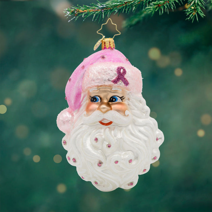 Strength in Pink ornament. This Santa head features a pink breast cancer awareness ribbon on his pink hat. View of front.