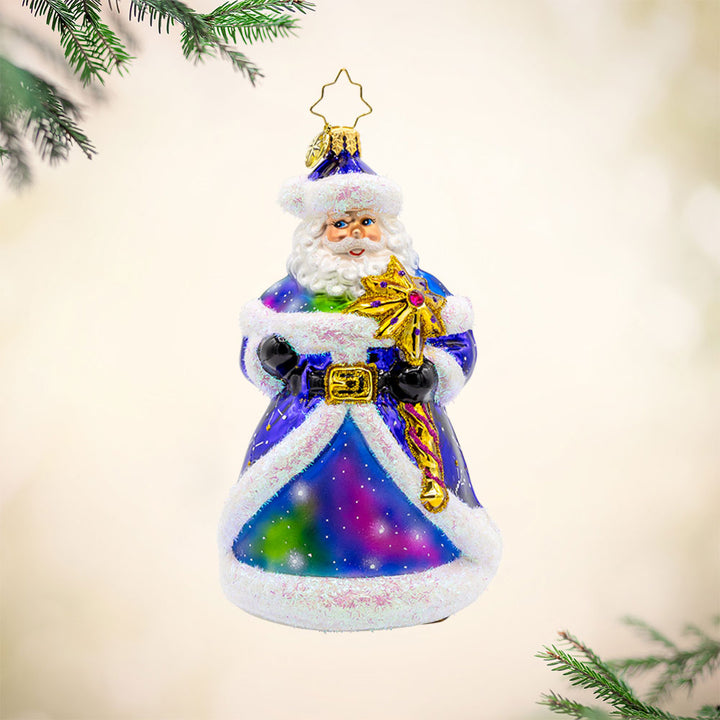 Celestial Claus ornament. This Santa has a galaxy swirling in his purple coat and constellations lighting up his robe. View of front.