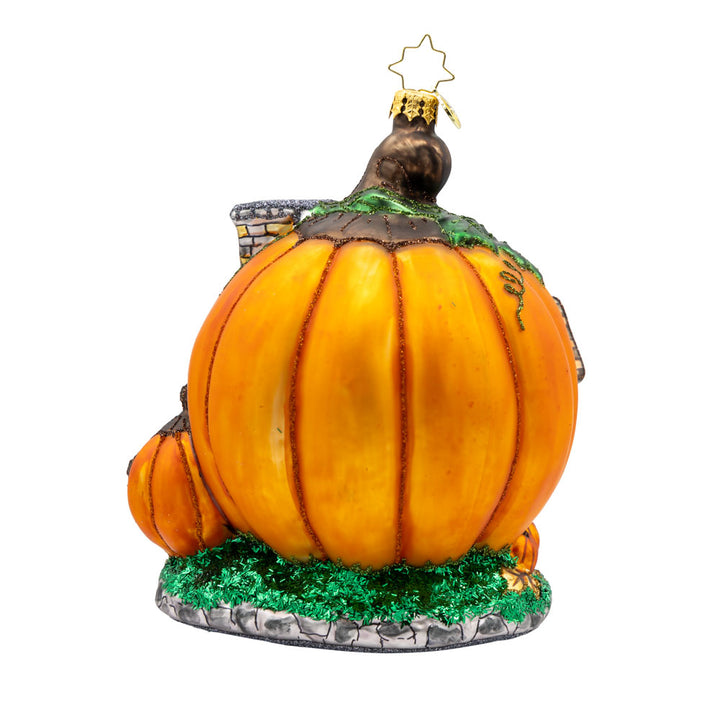 Pumpkin Patch Abode Ornament. Featuring a vibrant pumpkin exterior with windows, a whimsical door, and a leafy roof. View of back.
