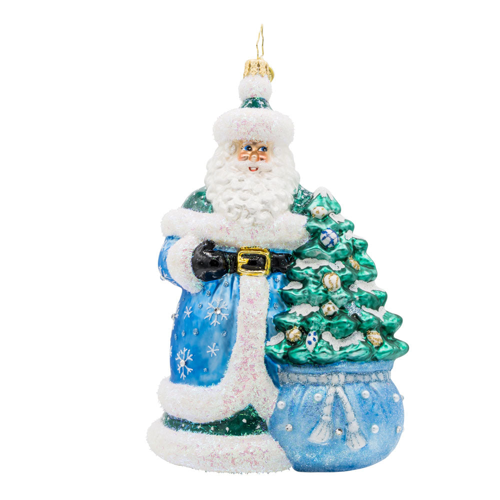 Christmas Enchanted Santa ornament. Santa dons' festive colors with sparkling details. A decorated Christmas tree is seen coming out of his gift sack. View of front. 