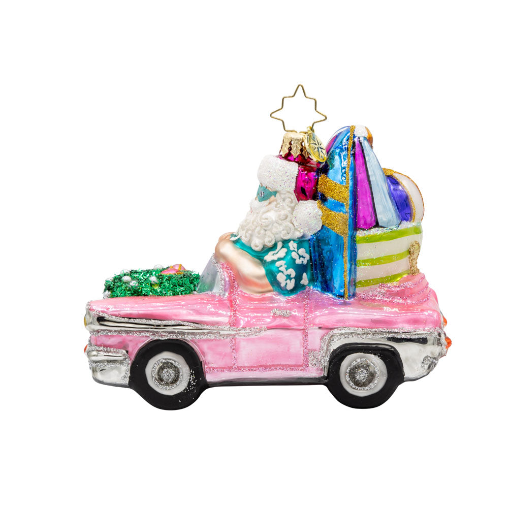Santa's Coastal Christmas Ride ornament. Santa drives a pink car with his surfboard, sunglasses, and beach gear. View of back.