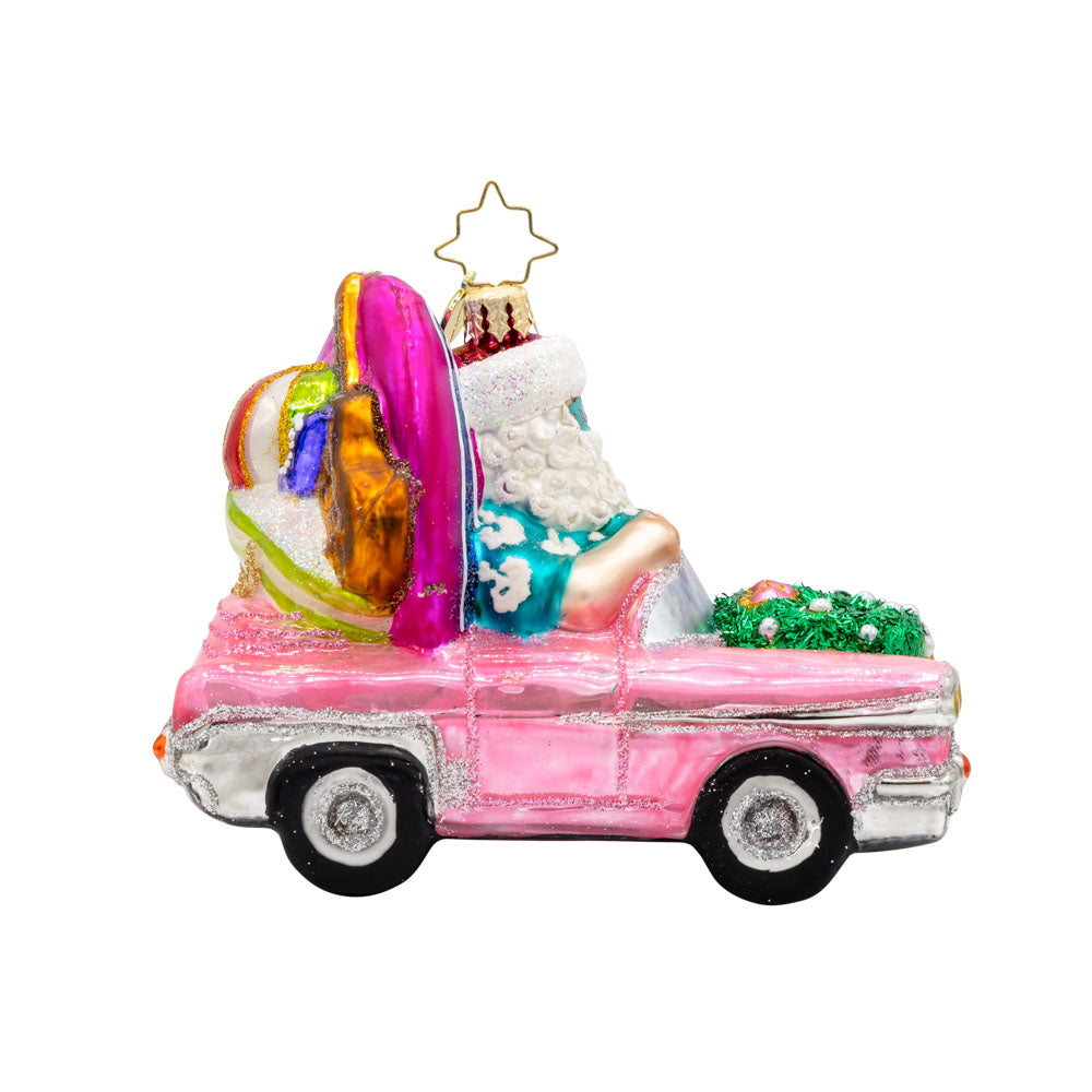 Santa's Coastal Christmas Ride ornament. Santa drives a pink car with his surfboard, sunglasses, and beach gear. View of front.