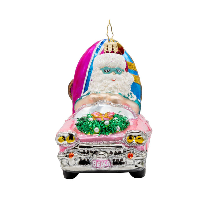 Santa's Coastal Christmas Ride ornament. Santa drives a pink car with his surfboard, sunglasses, and beach gear. View of right side.