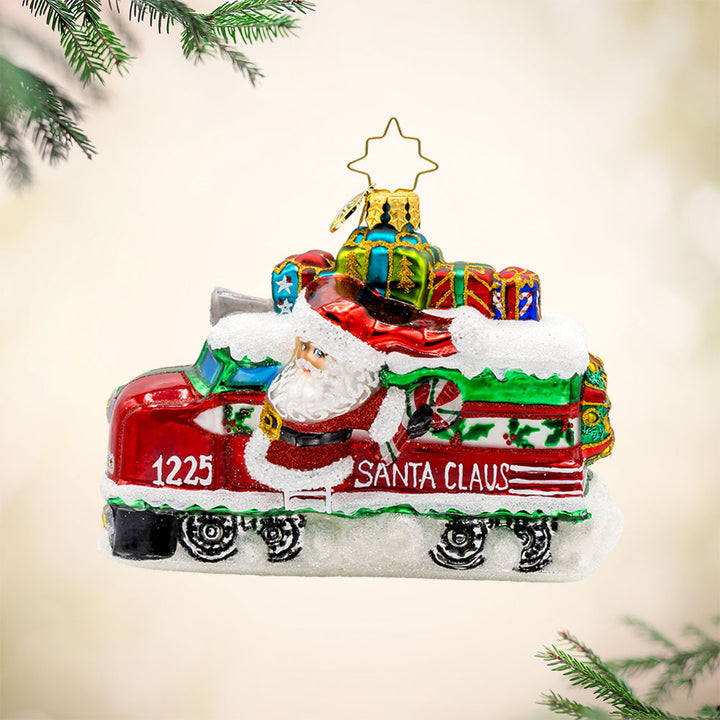 Claus the Conductor ornament.  This isn't your ordinary sleigh ride! Santa traded his reindeer for a train full of gifts. View of front. 