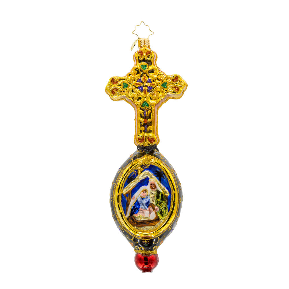 This exquisite ornament showcases a hand-painted nativity scene framed by a resplendent cross. Adorned with shimmering gems and vibrant colors. View of front.