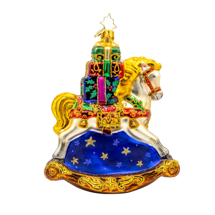 Rockin' Around Christmas ornament. Charming rocking horse with gifts stacked on its back. Hand-painted with a festive Christmas scene. View of left side.