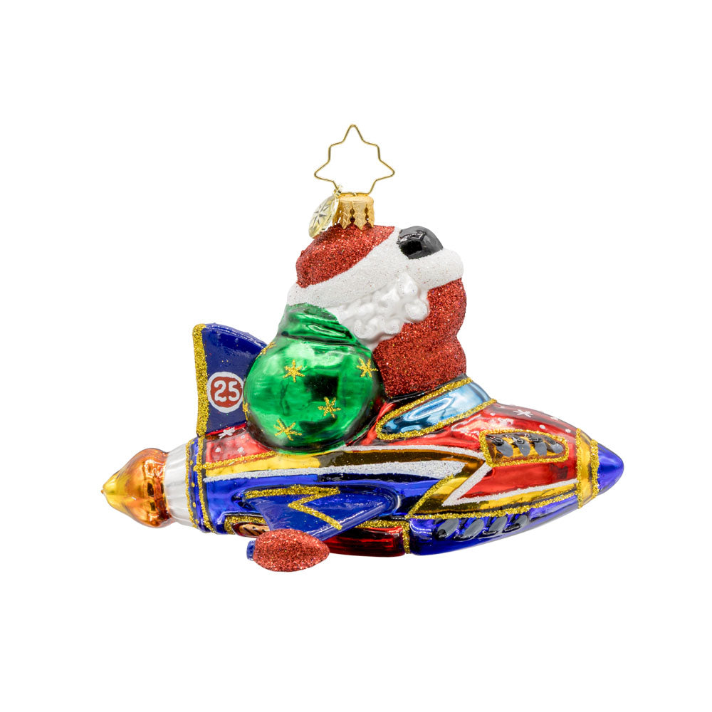 St. Nick's Yuletide Blast ornament. Santa rides in a rocket ship with a green gift sack in hand. View of back.