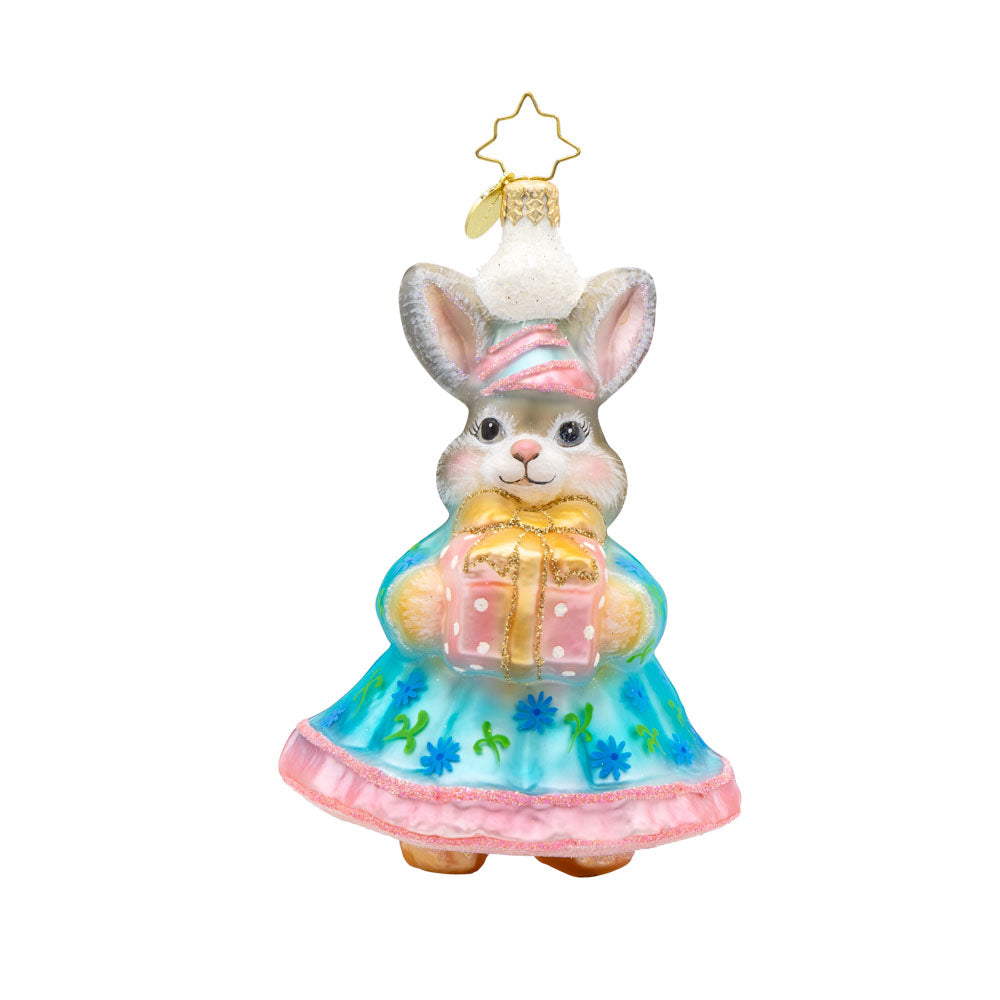 Hoppy Holiday ornament. This bunny is dressed in a blue and pink dress, with a gift in hand. View of front.