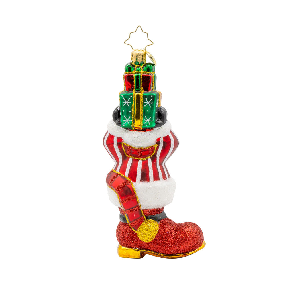 Snowman Surprise ornament. This snowman is wearing a striped sweater, popping out of a red boot, with a stack of gifts in hand. View of back.