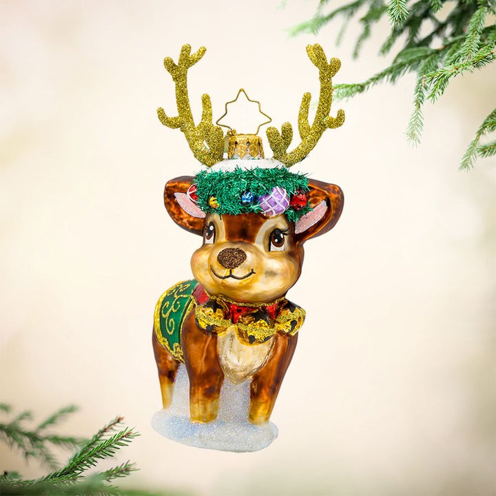 Festive Frosty Fawn ornament. This deer features sparkly antlers, a festive wreath, and jingling bells. View of front.
