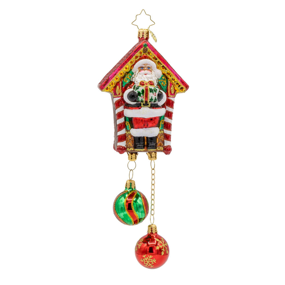 Jolly Timekeeper ornament. Santa holds a gift in the center of this festive take on a cuckoo clock. View of front. 