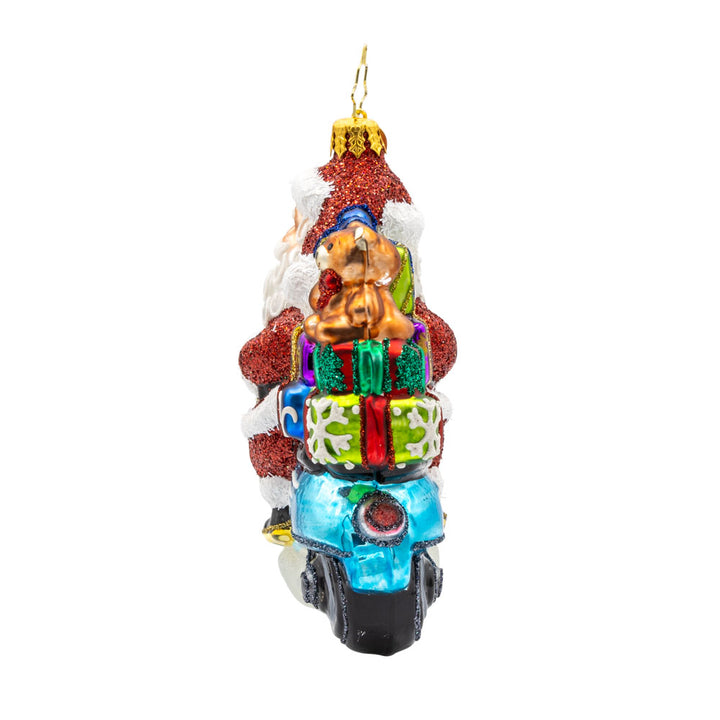 Vroom Vroom Voyage ornament. Santa is ditching the sleigh for a shiny Vespa full of gifts. View of right side.