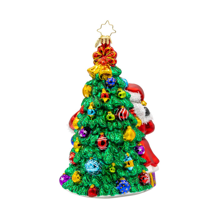 Holiday Harmony ornament. Santa and Mrs. Claus are decorating the tree with tinsel and trimmings. View of back.