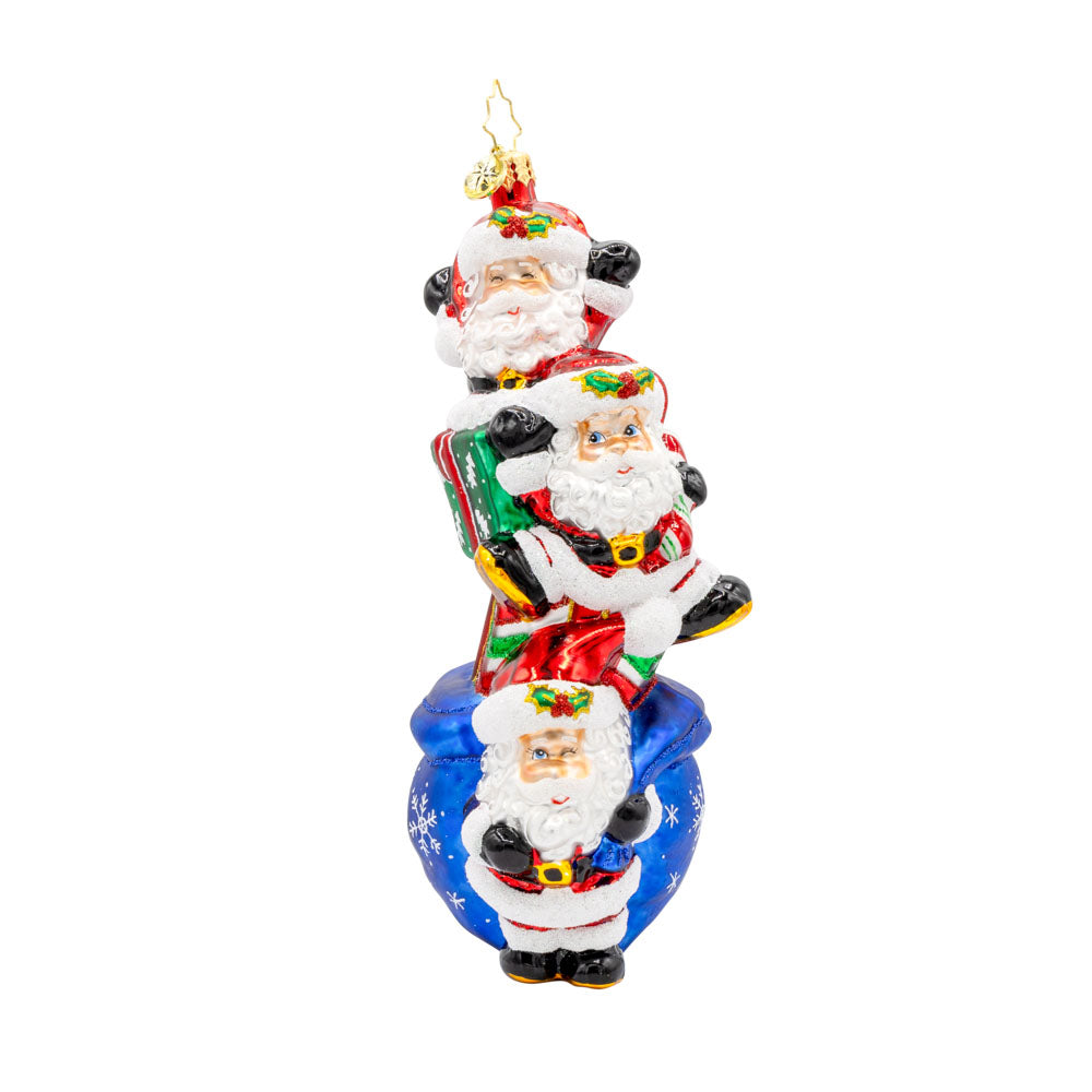 Jolly Santa Trio ornament. With their festive hats, sparkling eyes, and a bag full of gifts. View of front. 