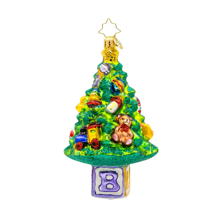 Bundle of Joy Spruce ornament. This piece features a decorated Christmas tree and a collection of baby-themed toys. View of back.