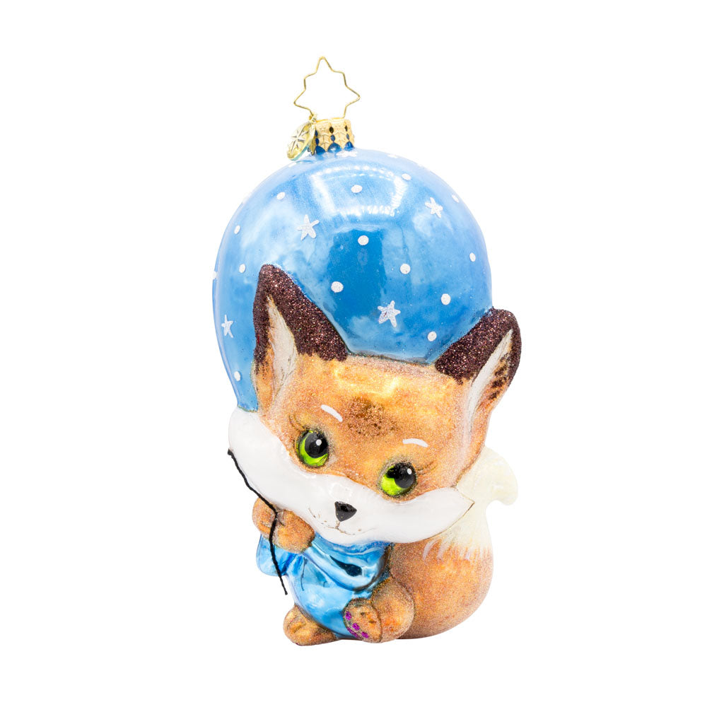 Blue Foxy Float ornament. Featuring a baby fox holding onto a blue balloon. View of front. 