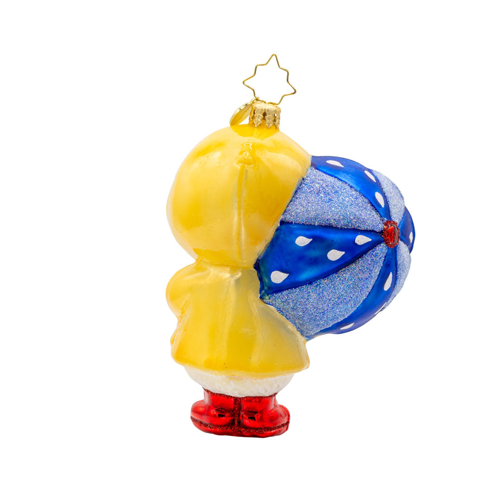 Rainy Day Duckling ornament. Dressed in a tiny, vibrant raincoat and rain boots, blue umbrella in tow. View of back.