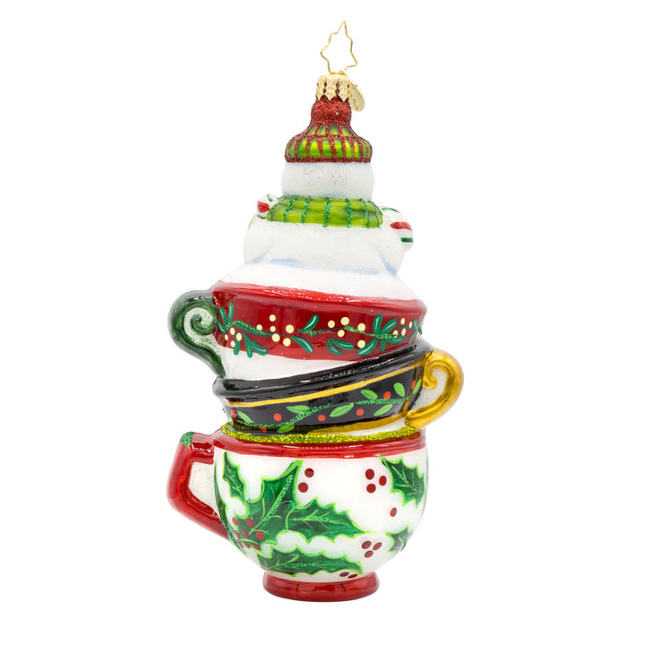 Teatime Treasures Ornament. Featuring a charming snowman nestled snugly inside a whimsical stack of teacups. View of back.