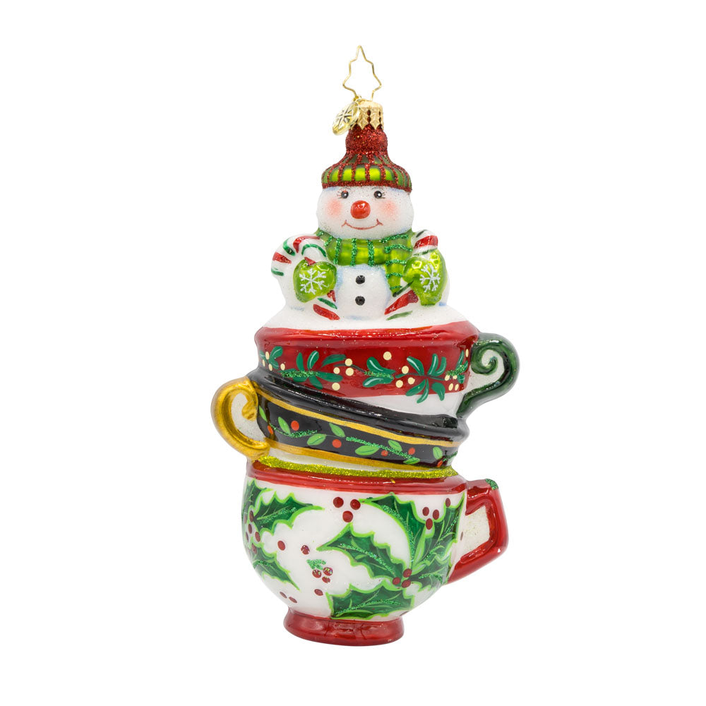 Teatime Treasures Ornament. Featuring a charming snowman nestled snugly inside a whimsical stack of teacups. View of front.