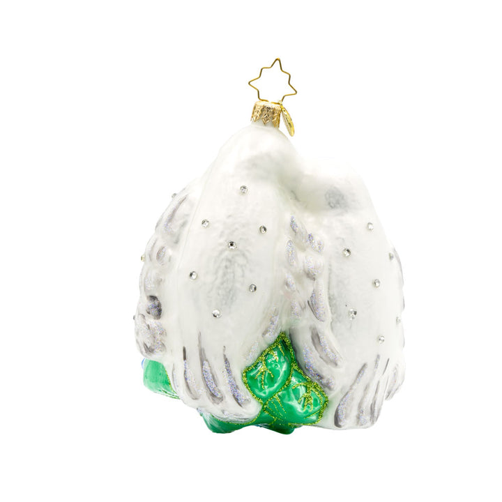 Wedding Lovebirds ornament. White birds are nestled into one another accompanied by pink flowers and a blue banner dated "2025." View of front. 