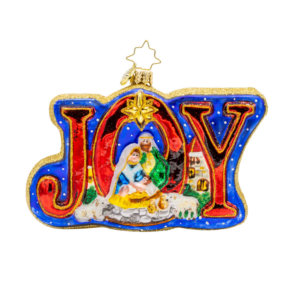 Holy Harmony ornament. Nativity scene with detailed figures of Mary, Joseph, baby Jesus, and the three wise men, shimmering star, and the word "JOY" shining brightly. View of front. 