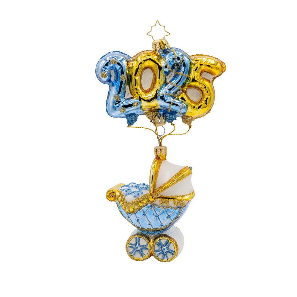Baby Blue Cradle of Celebration ornament. Features a decorated baby blue carriage and "2025" shaped balloons. View of front. 