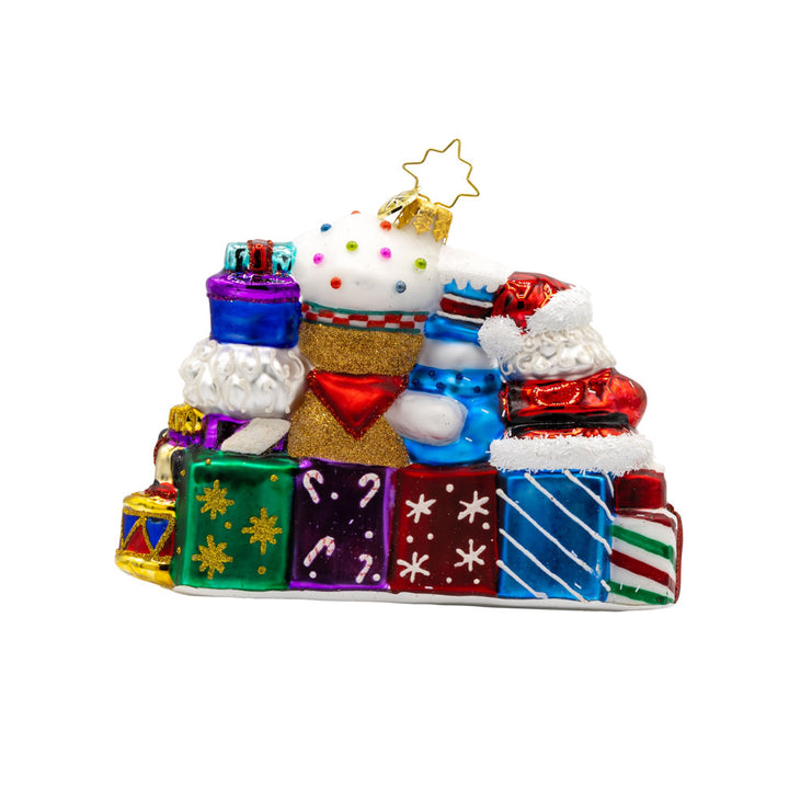 Stacking Up The Cheer ornament. A row of gifts dated with "2025." Behind them sits a snowman, gingerbread man, nutcracker and drummer boy. View of back.