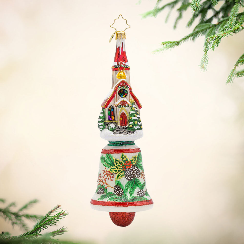 Chiming Church Charm ornament. This church features stained glass windows and a snow-covered roof atop a hand-painted bell. View of front.