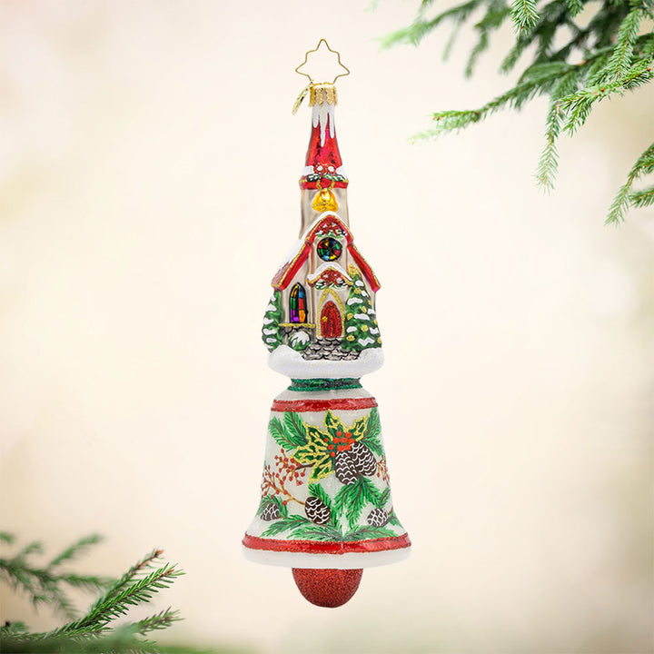 Chiming Church Charm ornament. This church features stained glass windows and a snow-covered roof atop a hand-painted bell. View of front.