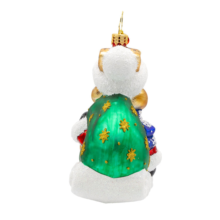 Healing Holiday Hare ornament. A rabbit donning a green cloak and red hat sits on a sleigh. View of right side.
