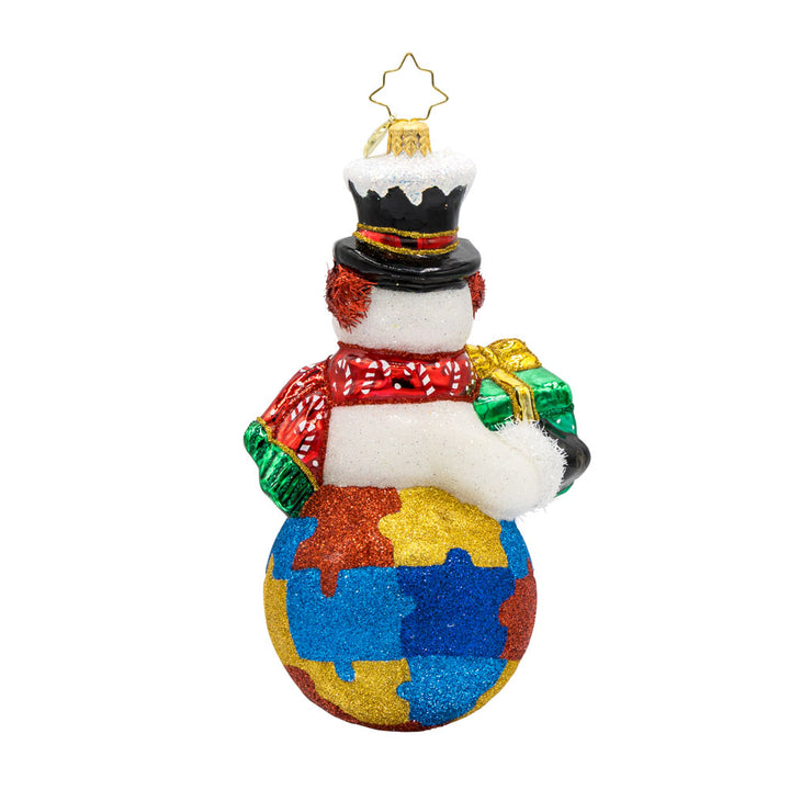 Puzzle Piece Pal ornament. This snowman is carrying a gift. His bottom half is painted to look like a jigsaw puzzle. View of back.