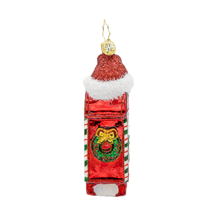 North Pole Postbox ornament. A festively decorated red postbox with "Letters to Santa" written on it. Topped with Santa's red hat. View of side.