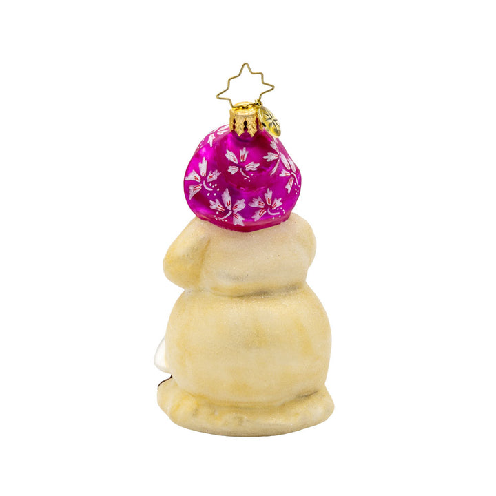 Coastal Chiller ornament. Sun-kissed snowman with a pink bucket, mittens, and flowered sun hat. Starfish buttons and a seagull friend in tow. View of back.