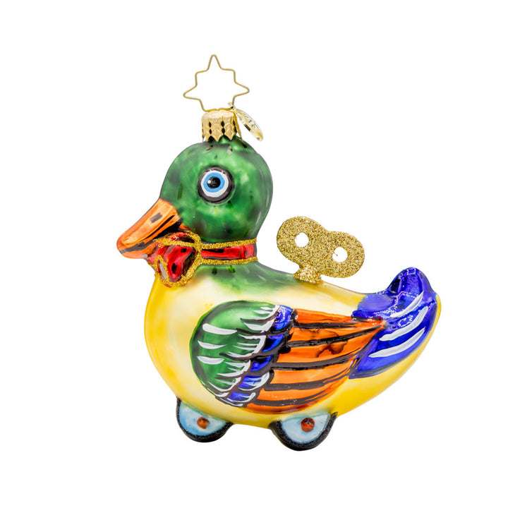 Dapper Duckling ornament. This wind-up duck dons' shiny green feathers, sparkling eyes, and a dapper red bow. View of back.