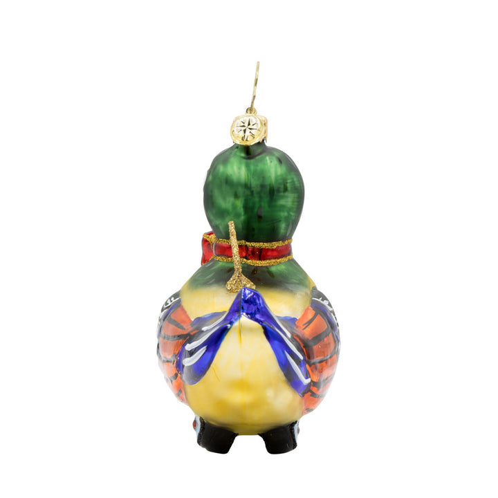 Dapper Duckling ornament. This wind-up duck dons' shiny green feathers, sparkling eyes, and a dapper red bow. View of left side.