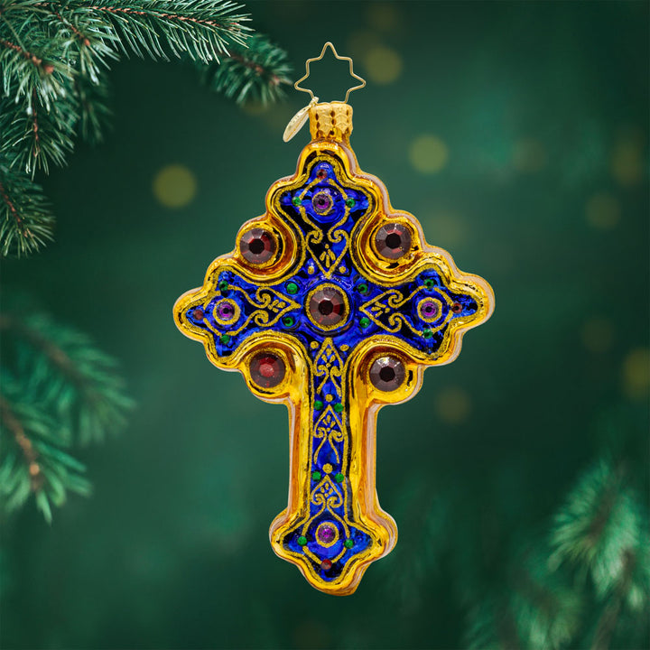 Blessed Beacon ornament. Royal blue cross adorned with gold designs and jewels. View of front. 