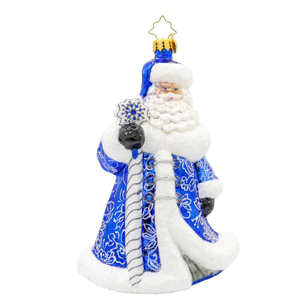 Chinoiserie Santa Charm ornament. Donning a blue satin gown adorned with intricate floral patterns, silver glitter ties, and deep blue gems. View of front.