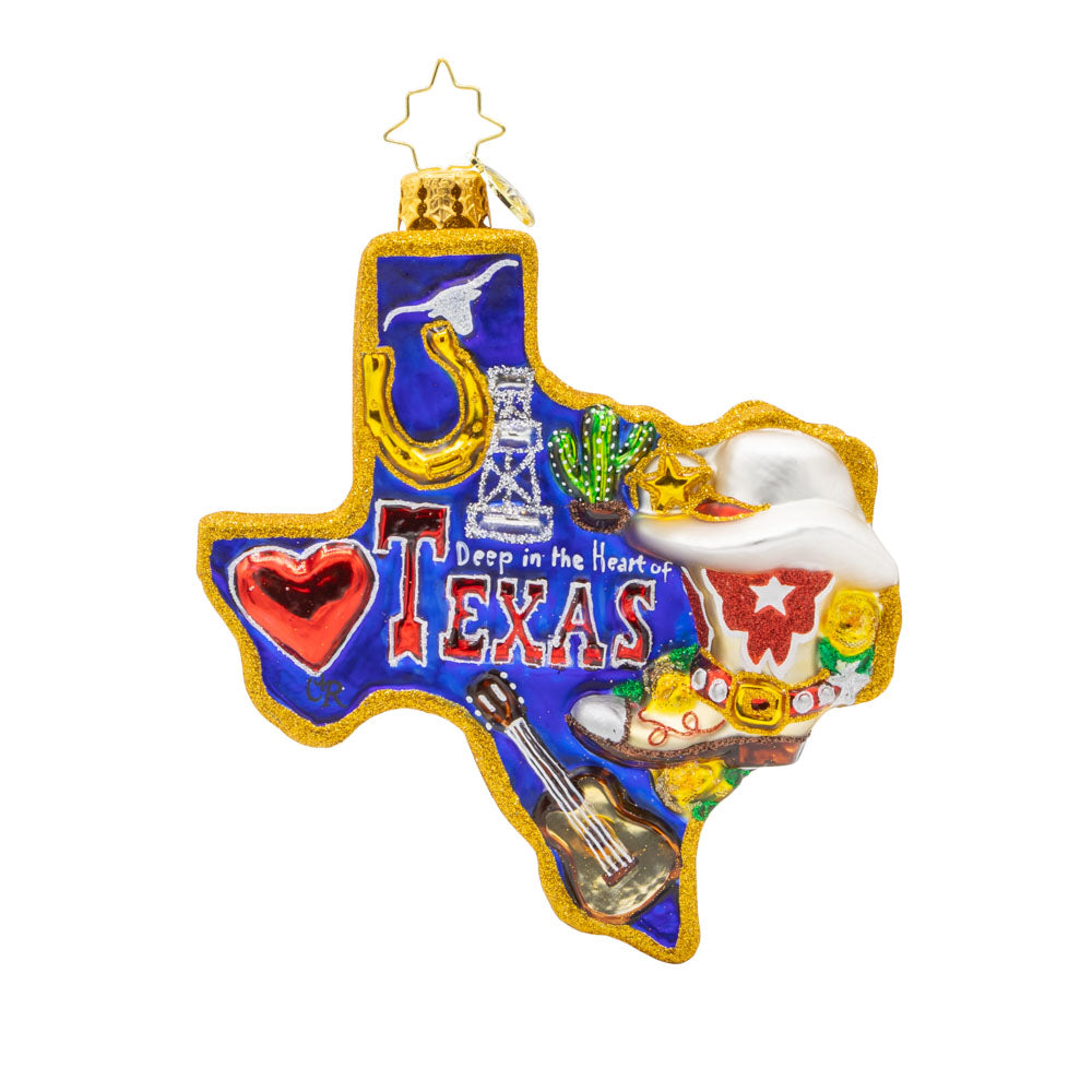 Lone Star Pride ornament. Shaped like the great state itself, the glittering blue, white, and red of the Texas flag on the back to the golden horseshoe and oil rig, every detail tells a story of Texan pride. View of front. 