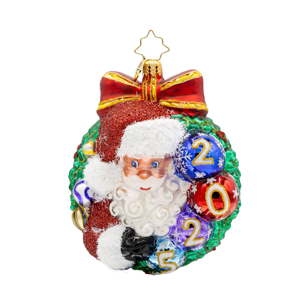 Smiling Through 2025 ornament. Santa is encircled by a Christmas wreath. Ornament balls are dated with "2025." View of front.