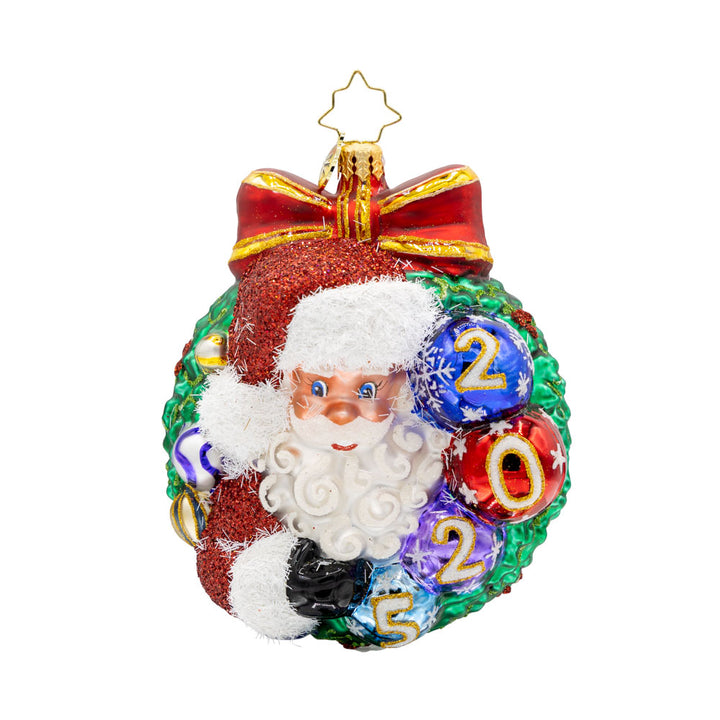 Smiling Through 2025 ornament. Santa is encircled by a Christmas wreath. Ornament balls are dated with "2025." View of front.