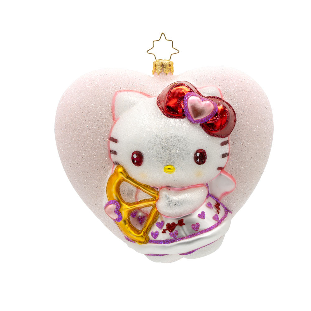 Hello Kitty Sweetheart ornament. Dressed as a Cupid, complete with a bow and arrow, she's surrounded by hearts and glitter. View of front. 