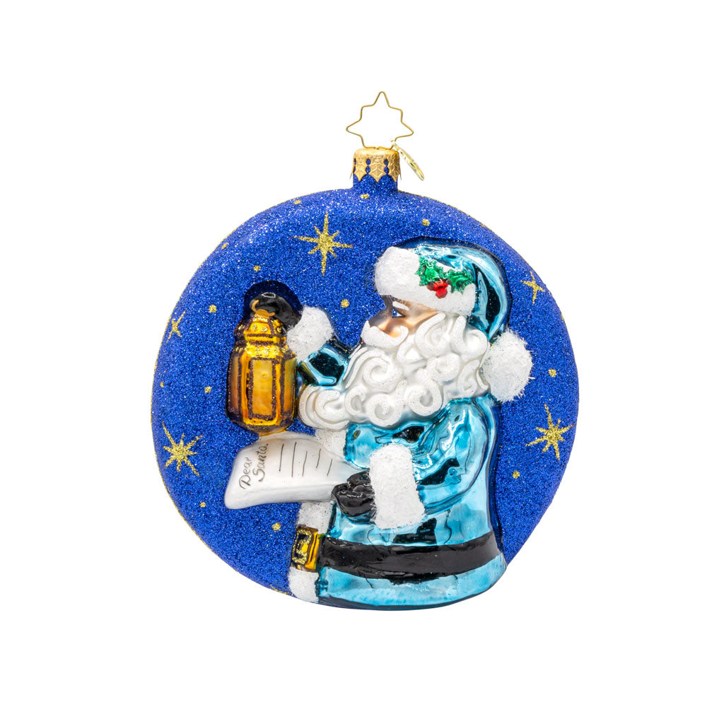Santa's Guiding Light ornament. Santa wears blue, a "Dear Santa" letter in hand and lantern in the other walking through a starry night. View of back.