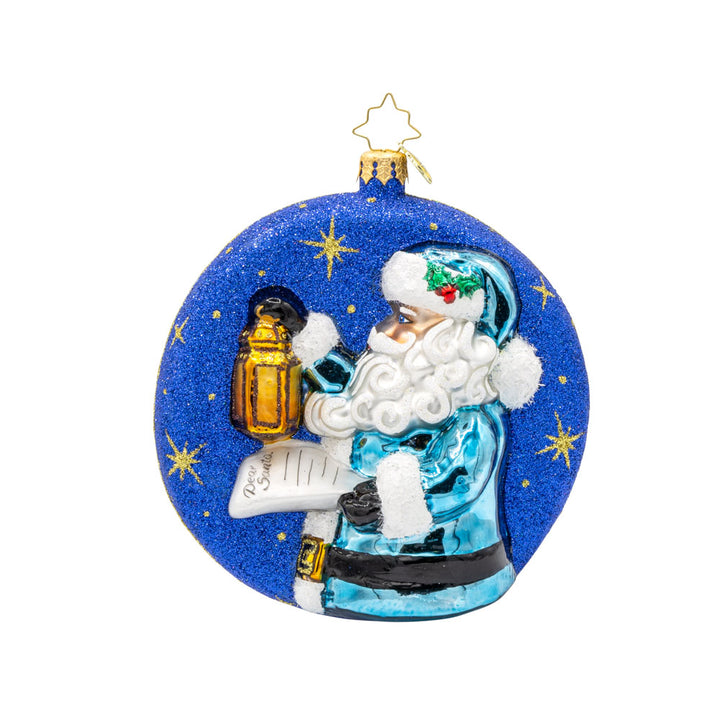 Santa's Guiding Light ornament. Santa wears blue, a "Dear Santa" letter in hand and lantern in the other walking through a starry night. View of back.