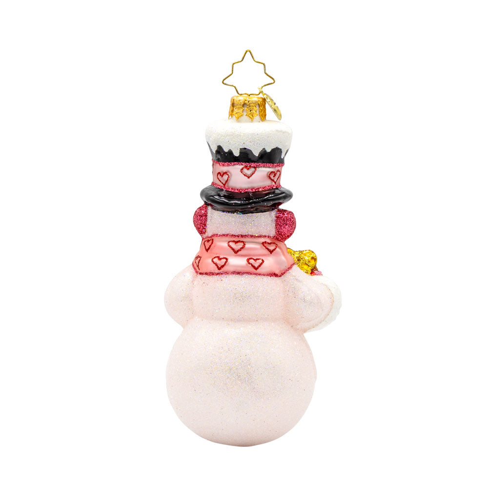 Snowy Valentine ornament. Featuring a heart-shaped scarf and glittery red details. View of back.