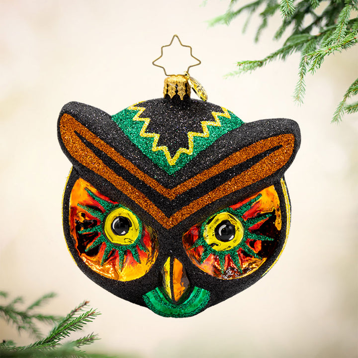 Hoot of the Night ornament. This owl features spooky eyes, vibrant colors of glittering black, yellow, orange, and green. View of front.